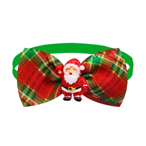 Detail of red and green plaid pet bow tie featuring a resin Santa Claus ornament