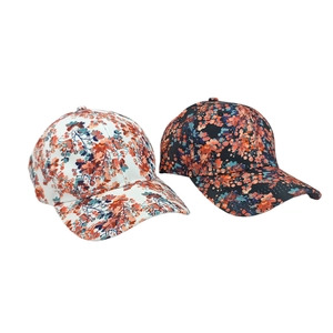 Detail of floral baseball caps showing high-quality print patterns on white and black fabric