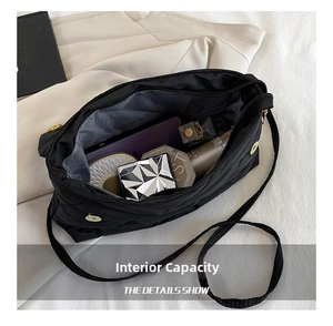 Detail view of large capacity interior for quilted crossbody bag with zip closure