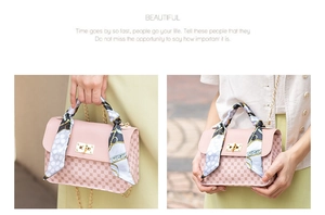 Pink printed crossbody bag with gold chain strap and silk scarf detail on a model