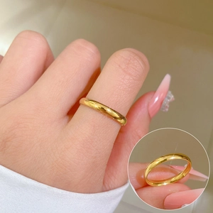 Minimalist polished gold titanium steel geometric band ring shown on hand with detail view