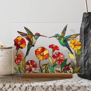 Floral acrylic table decor with hummingbirds and a wooden base in a cozy setting