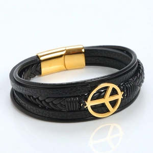 Detail view of multi-layer black leather bracelet with golden peace sign and magnetic clasp
