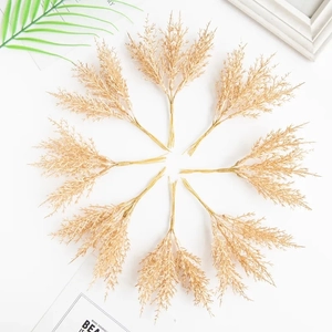 Flat lay of artificial champagne cedar grass stems for DIY floral wreaths and wedding decor