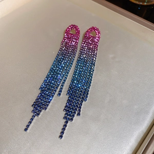 Detailed view of luxury long tassel earrings with gradient pink and blue rhinestones