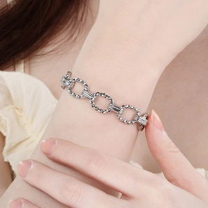 Elegant silver stainless steel twisted cable link bracelet worn on a female wrist