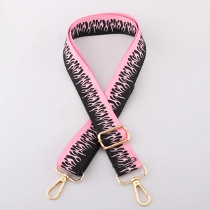 Detail of 38mm pink and black striped bag strap with flame pattern and gold metal hooks