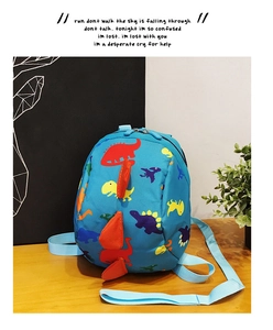 Detail of blue dinosaur backpack with 3D orange spikes and adjustable straps