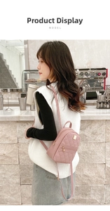 Detail of pink mini backpack with rhombus quilted pattern and metallic brand plate