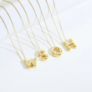 Golden alphabet necklace with pearls W S O H letters on minimalist white display