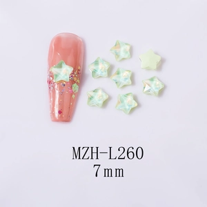 Detailed view of 7mm light green star-shaped iridescent nail crystals and application