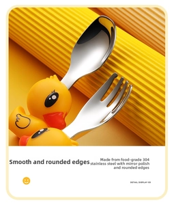 Close-up of polished 304 stainless steel baby spoon and fork with yellow duck handles