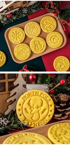 Festive Christmas cookies with embossed Santa and snowflake patterns on a rustic wooden tray