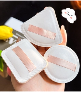Three-piece set of white triangle, square and round soft makeup puffs with pink ribbon handles