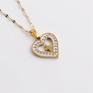 Gold stainless steel heart necklace with crystal cross pendant on a white background