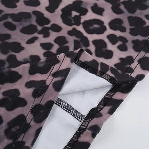 Detailed macro view of the leopard print hemline with clean stitching on gray fabric