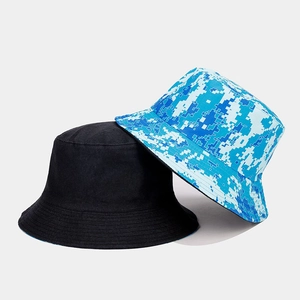 Detail shot of a black canvas bucket hat and a blue digital camouflage fisherman hat
