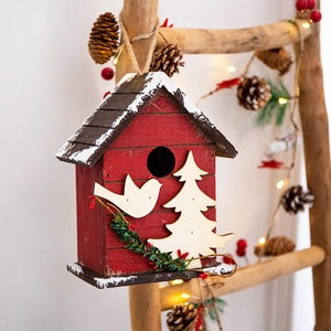 Red birdhouse Christmas ornament with wooden bird and tree on decorative ladder