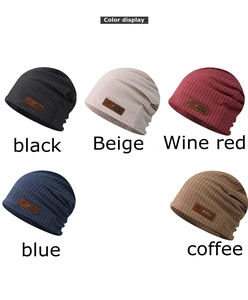 Color display of knitted beanies in black beige wine red blue and coffee with leather labels