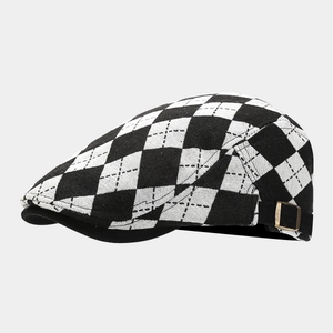 Close-up of black and white argyle pattern and metal side buckle on the ivy cap