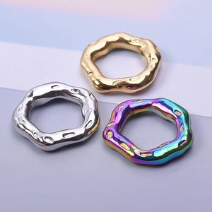 Textured lava-style stainless steel rings in gold, silver, and rainbow finishes
