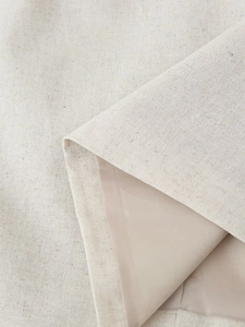 Close-up of linen blend fabric with smooth lining showing texture and dual-layer structure