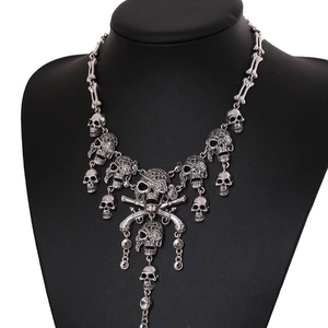 Statement silver skull necklace with pirate pendant and tassel bone links on a model