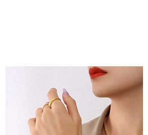 Close-up of minimalist 18K gold plated mechanical rabbit necklace and ring on a model