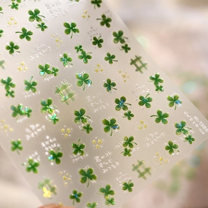 Detail view of M-1386 four-leaf clover nail stickers with laser textures and green patterns