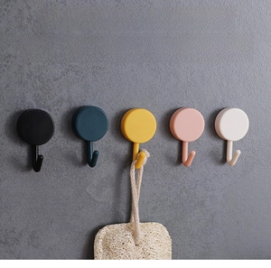 Detail of five-color rotating wall hooks showing 360-degree swivel and adhesive mounting