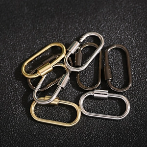 Macro shot of oval metal screw clasps in gold silver and black on leather