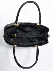 Internal view of black woven handbag showing main compartment and gold hardware details