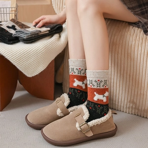 Detail of warm Christmas socks with dog patterns and brown fuzzy mule slippers