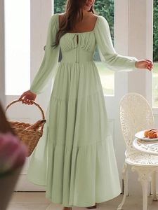 Detail of light green tiered maxi dress with square neck and tie-front bodice design