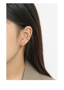 Close-up of elegant gold hoop earrings and ear cuff set on model in French vintage style