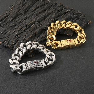 Macro shot of punk style steel chain bracelet with red-eyed skull clasp detailing