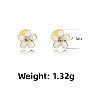 Detail shot of flower earrings with white enamel petals and 8.5mm zircon center