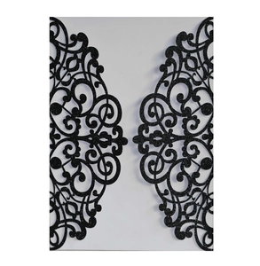 Detailed laser-cut black glitter card wedding invitation with symmetrical vine patterns