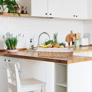 Detail of paper rope storage basket with beige fabric liner and wooden handles