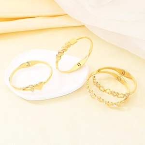 Elegant gold heart bracelets with hollow designs and sparkling crystals on stone decor