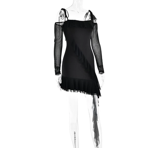 Detail view of black off-shoulder dress with ruffle hem and sheer mesh sleeves