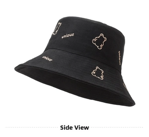 Detailed view of black cotton bucket hat with beige bear embroidery and unique lettering