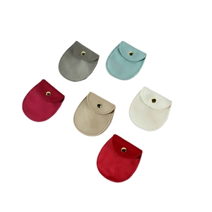 Set of six velvet jewelry pouches with gold snap buttons in various elegant colors