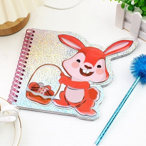 Detail of spiral notebook with silver glitter cover and red cartoon rabbit Easter design
