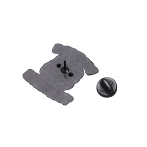 Black metal dinosaur enamel pin back showing textured surface and rubber butterfly clutch