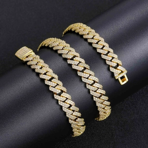 Detailed view of three 10mm golden cuban link chains with zircon pavé on a black display