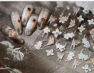 Detail of holographic butterfly and floral nail art stickers with relief texture