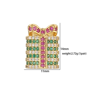 Detailed macro view of festive gold gift box stud earrings with colorful crystals