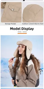 Detail view of khaki winter trapper hat with button pocket and quilted insulation