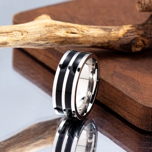 Macro shot of silver titanium steel ring for men with dual black stripe resin inlay